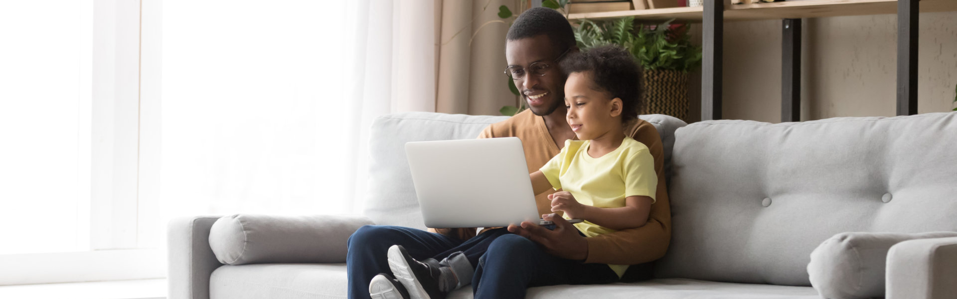 father and son using a laptop