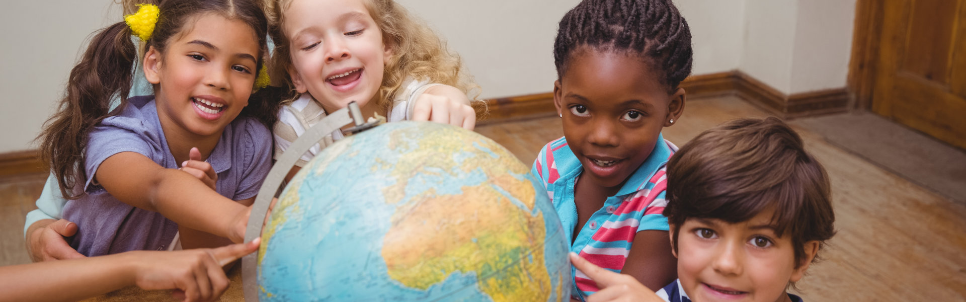 kids holding the globe