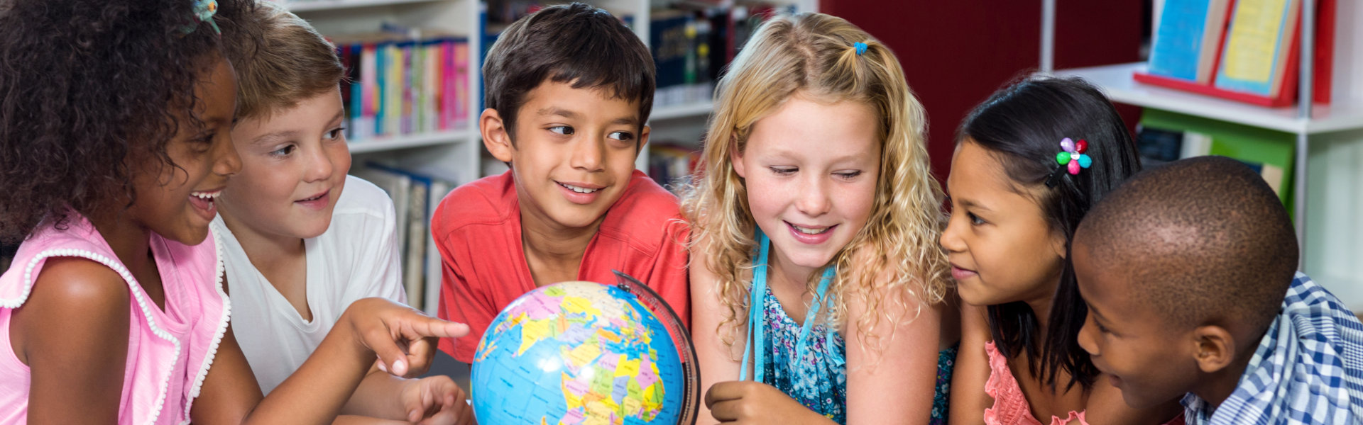 kids pointing at the globe